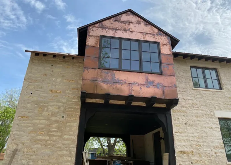 Copper metal panel facade on a stone building for Metal Roof Coating in Eagle Pass