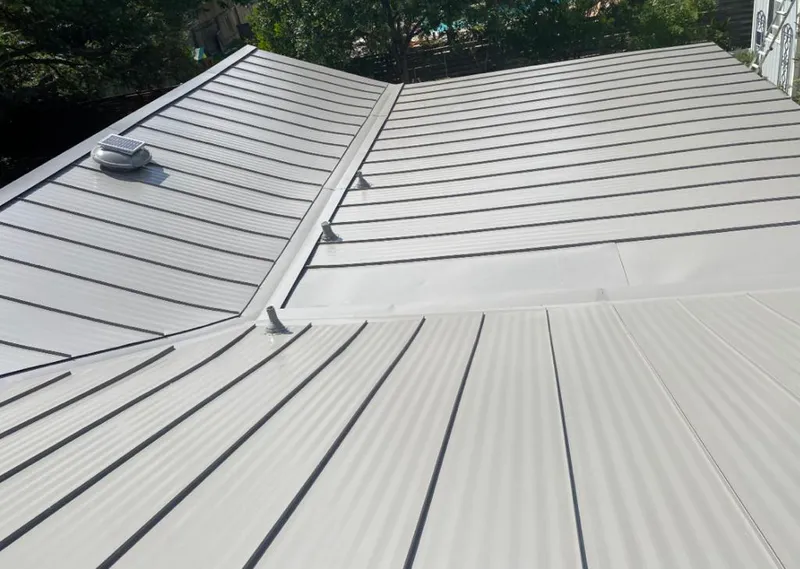 Solar attic fan installed on a metal roof for Roof Ventilation in Eagle Pass